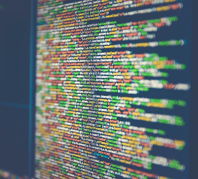 Close-up of a computer monitor filled with lines of colourful program code.