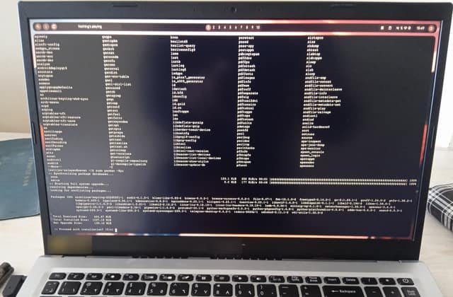 A laptop screen full of typed commands while the operating system downloads and installs its own updates.